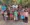 Father Joseph Camilleri standing with a group of Guatemalan children and mothers, showcasing the impact of his work through Guatemala Missions