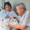 Father Joseph Camilleri holding a newborn baby at the hospital he built in Guatemala, a testament to his dedication to improving healthcare for the community.